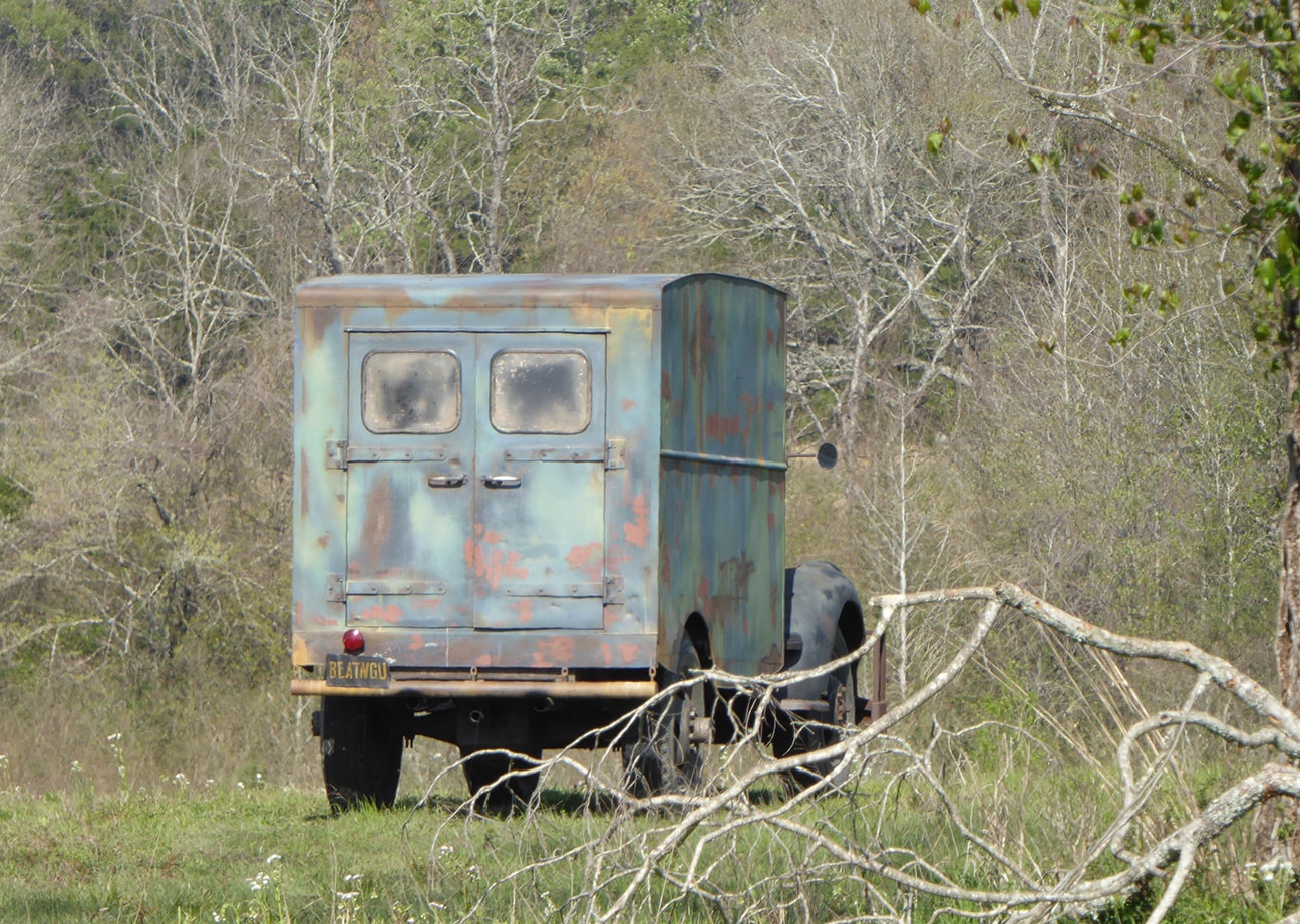 Vintage pickup truck on open country road